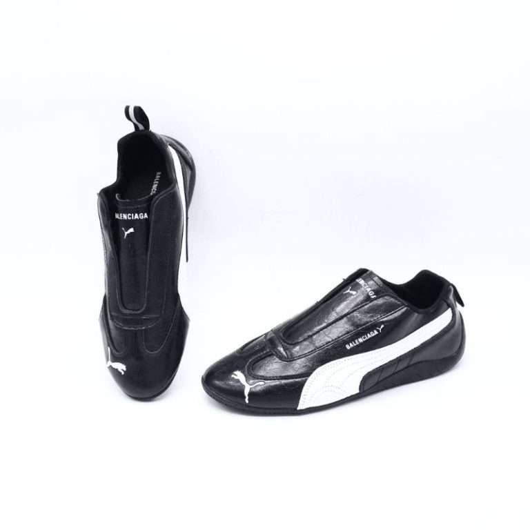 The Balenciaga x Puma Speedcat Leather Black is a stunning fusion of motorsport heritage and high-fashion craftsmanship. Designed for those who appreciate minimalist detailing wrapped in luxury, this sneaker elevates a classic silhouette into something truly iconic. Its sleek profile and low-cut shape are inspired by race-driving shoes, ensuring an aerodynamic look that hugs the foot naturally. The upper is constructed from premium black leather, offering a soft yet durable feel that stands the test of time. Every stitch contributes to a luxurious aesthetic, while maintaining the comfort and flexibility needed for everyday movement.