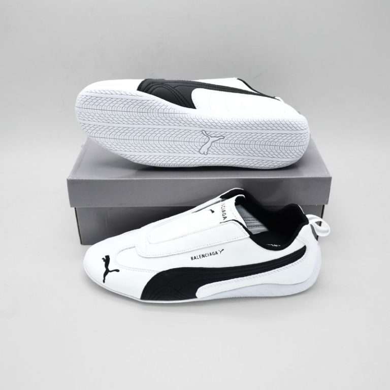 The Balenciaga x Puma Speedcat Leather White is a bold fusion of motorsport heritage and luxury streetwear design, redefining what a lifestyle sneaker can be. Built on the legacy of Puma’s iconic Speedcat silhouette, this collaboration elevates the classic racing-inspired profile into a premium fashion statement. The upper is crafted from high-quality leather in a clean, crisp white shade that delivers a minimalist yet striking aesthetic. The smooth texture and sleek contours reflect the aerodynamic influence of racing footwear, while subtle stitching details and the co-branded logo add a touch of sophistication and exclusivity.