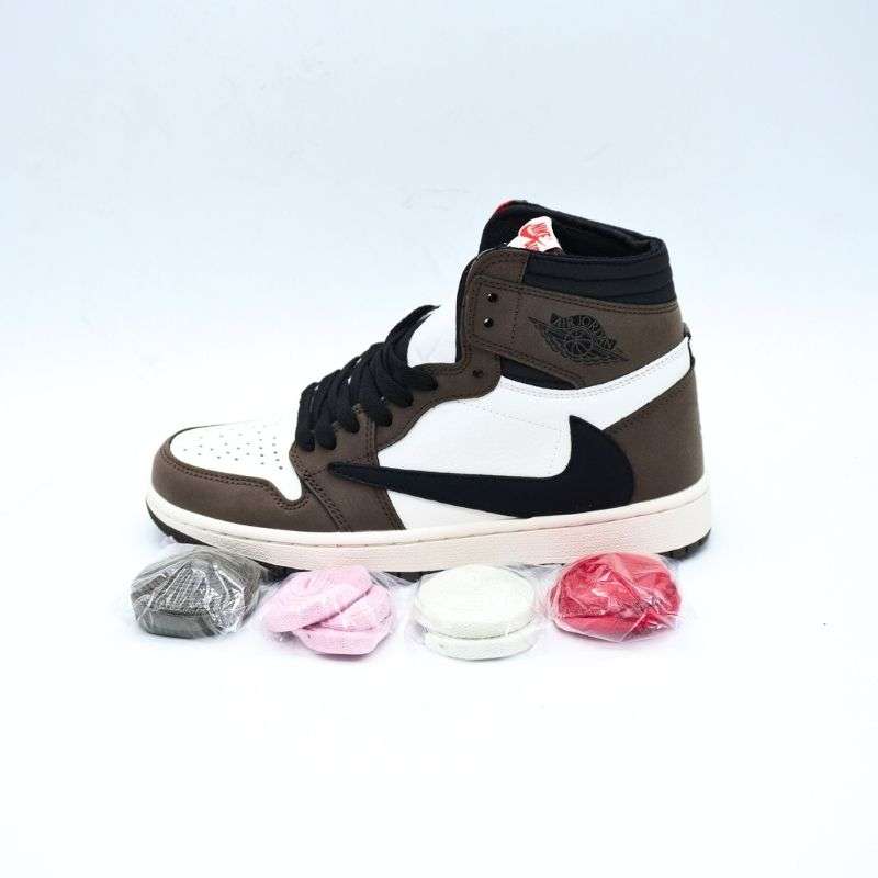 The Air Jordan 1 High “Travis Scott” is a cultural phenomenon disguised as a sneaker. Blending the classic heritage of Jordan Brand with the rebellious creativity of Travis Scott, this model transforms the iconic silhouette into something bold and unconventional. The first thing that captures attention is the oversized reverse Swoosh on the lateral side. This single design twist instantly sets the shoe apart from traditional releases and speaks to the idea of breaking rules and rethinking standards.